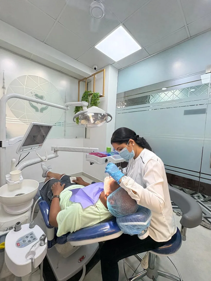 Dr. Vandana Gupta treating a patient in a modern, well-equipped treatment room at Imperial Dental, Mayur Vihar